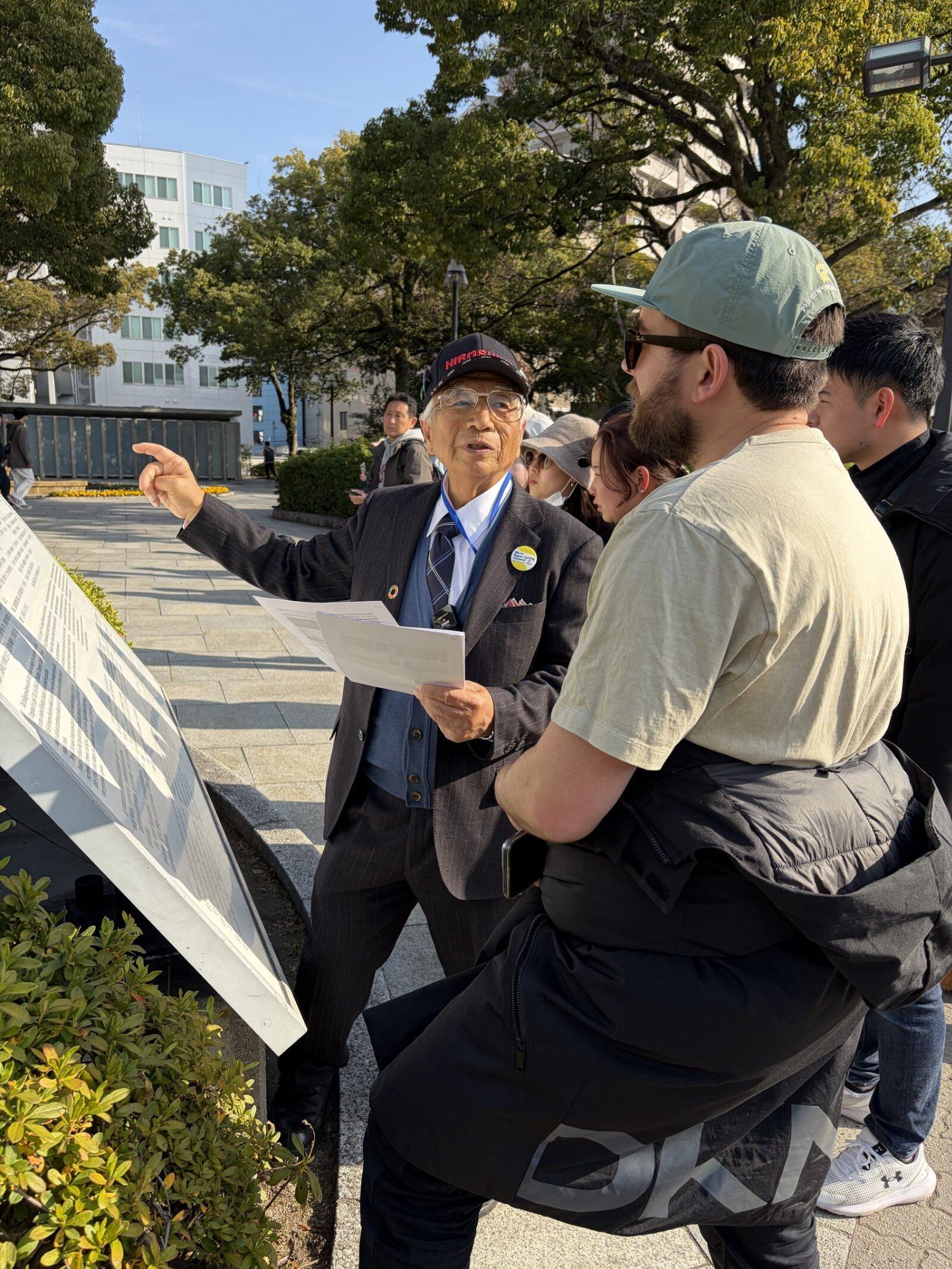 Iida guiding visitors